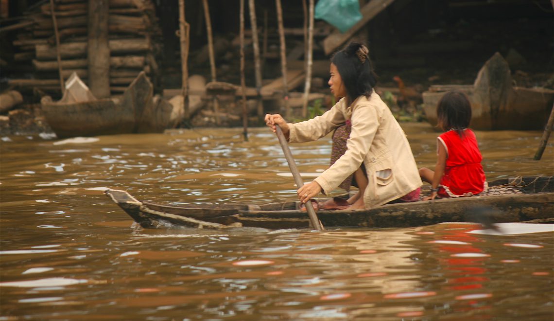 woman rowing on the Tonlé Sap, Tonlé Sap, Cambodian woman, mother and child, floating village, boat, Khmer culture, Siem Reap, Cambodia, villages of Cambodia, rural Cambodia, freshwater lake, living on a Lake, Kampong Khleang, communities of Cambodia, community, travel, South East Asia, Asia