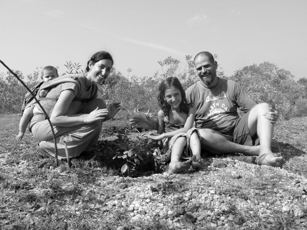 founder of Sadhana Forest, Aviram Rozin with his family, Yorit Rozin, Aviram and Yorit Rozin, planting trees, alternative living, Sadhana Forest, Auroville, living in a commune, community living, communities, reforestation, water conservation methods, forest, Pondicherry, Puducherry, Tamil Nadu, India, South India, experiences in Auroville, environment, environmental protection, environmental awareness, eco travel, green travel, save the earth, green planet, voluntourism, volunteer opportunities, social causes, social change, carbon footprint, self sustainability, travel